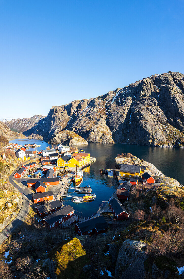 Nusfjord traditional fishing village with wooden rorbu on a sunny day in spring, Nusfjord, Lofoten Islands, Norway, Scandinavia, Europe