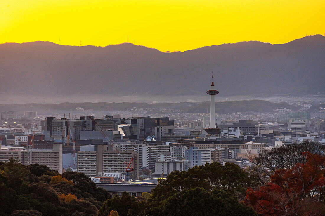 Kyoto skyline at sunset with a vibrant orange sky, Kyoto Tower, Kyoto, Honshu, Japan, Asia