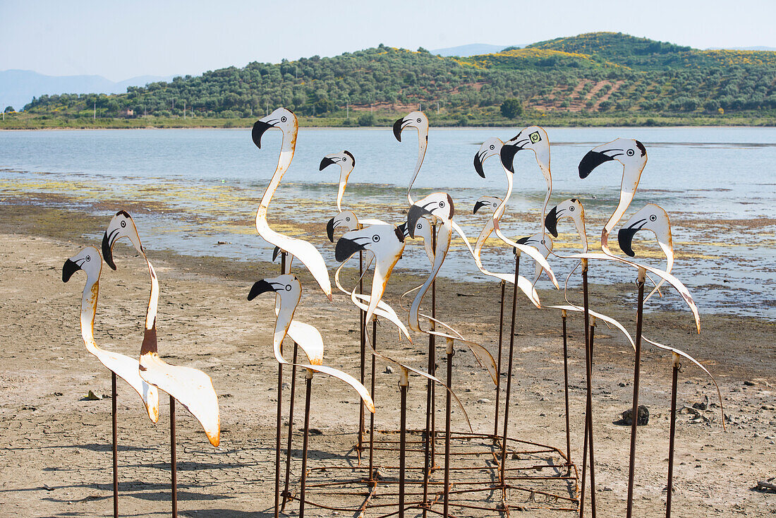 Artificial flamingos arranged near the wooden bridge connecting to the Byzantine Zvernec Monastery on Zvernec Island within the Narta Lagoon, on the Adriatic Sea, North of Vlora, Albania, Europe