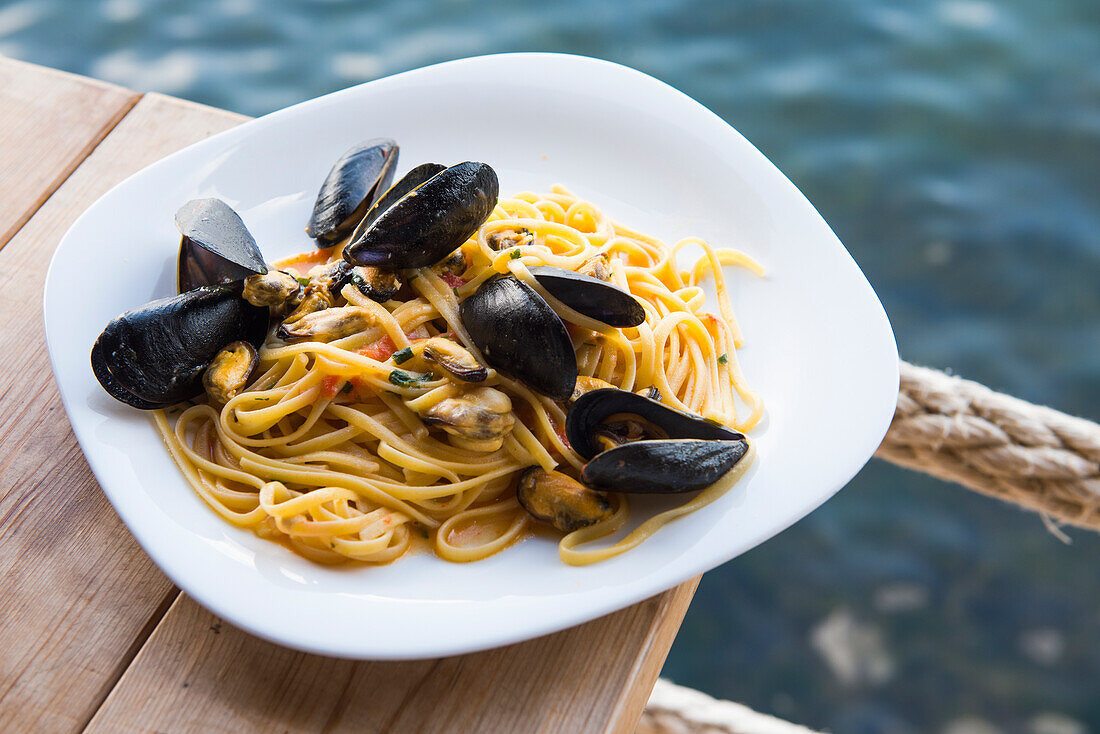 The Mussel House restaurant specialities of Bouchot mussels from Lake Butrint on the edge of which it is located, in Ksamil, near Saranda, Ionian coast, Albania, Europe