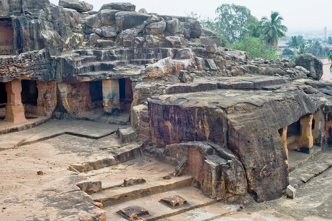 Monks' cells cut into the hillside rock among the Udayagiri and Khandagiri caves dating back to over 100 years BCE sculpted as religious retreats for Jain devotees, Bhubaneswar, Odisha, India, Asia