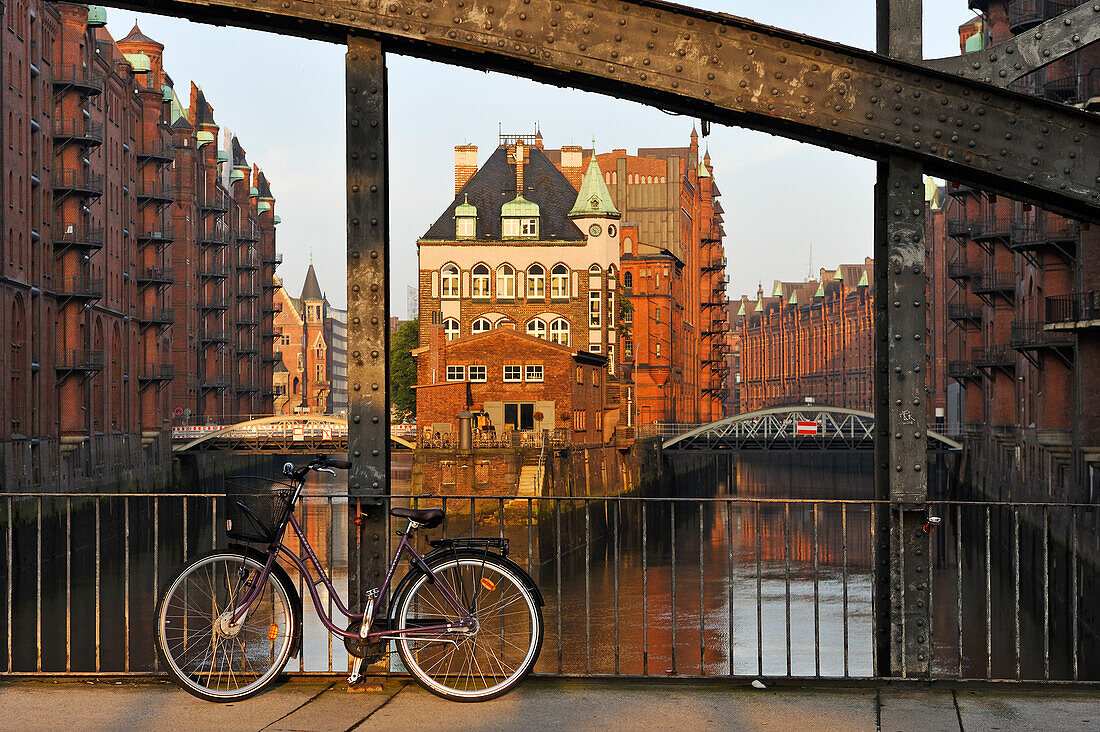 Tea house and restaurant Wasserschloss in the warehouse district (Speicherstadt) viewed from the PoggenmuhlenBrucke bridge, HafenCity district, Hamburg, Germany, Europe