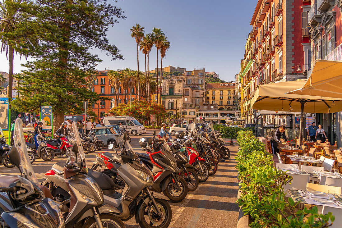 View of motorcycles, restaurant and colourful architecture in Piazza della Vittoria, Naples, Campania, Italy, Europe