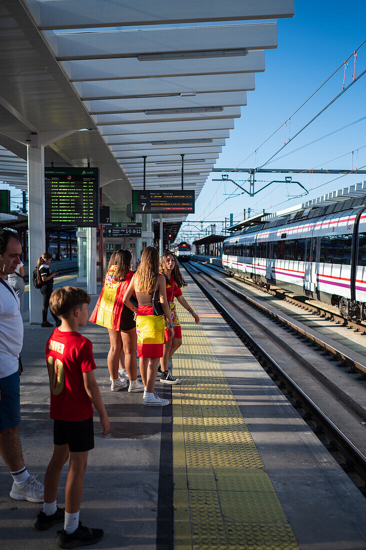 Spanish fans wait for the train to join street celebrations in Madrid after Euro 2024 champions Spain returned home to a royal welcome, Madrid