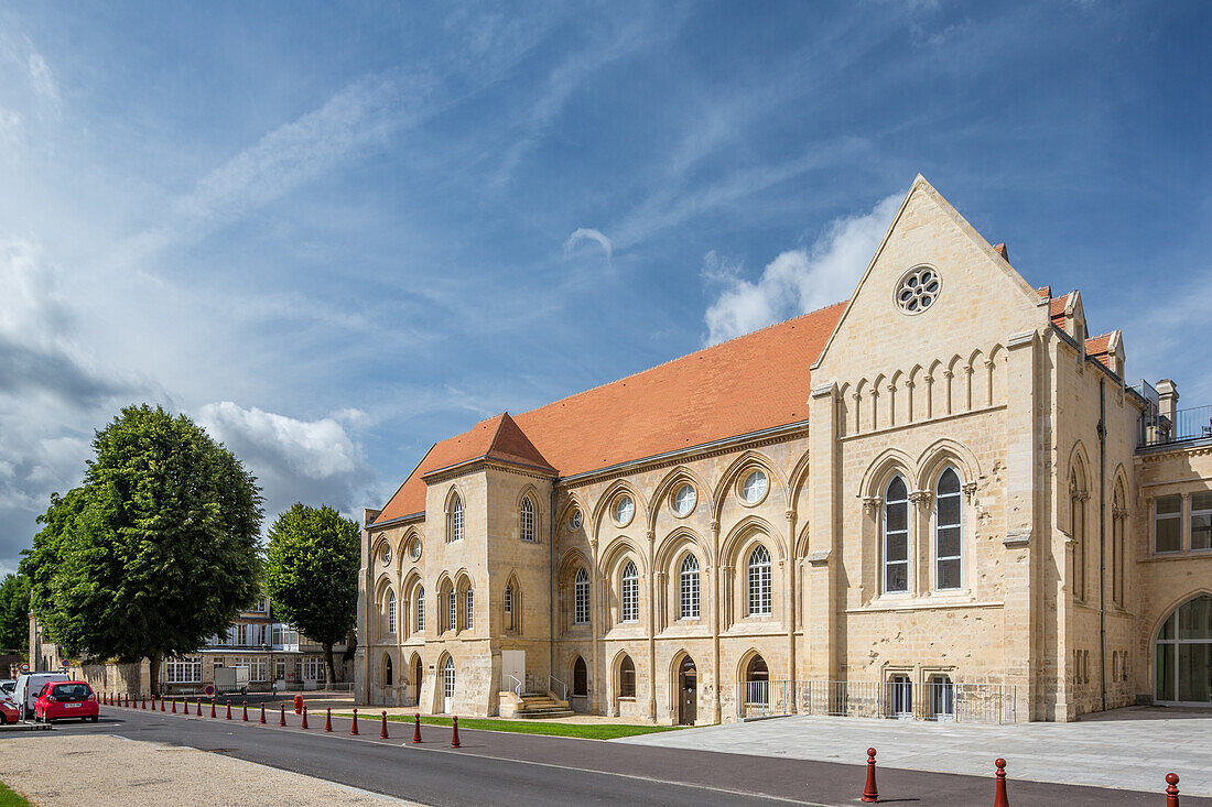 Elegant view of the historic Palais Ducal de l'abbaye aux Hommes located in Caen, Normandy, France. The stunning architecture stands out against a partly cloudy sky.