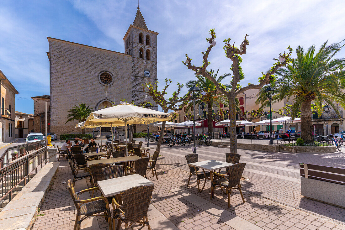 View of cafe and church in Placa Mayor in hilltop town of Campanet, Majorca, Balearic Islands, Spain, Mediterranean, Europe