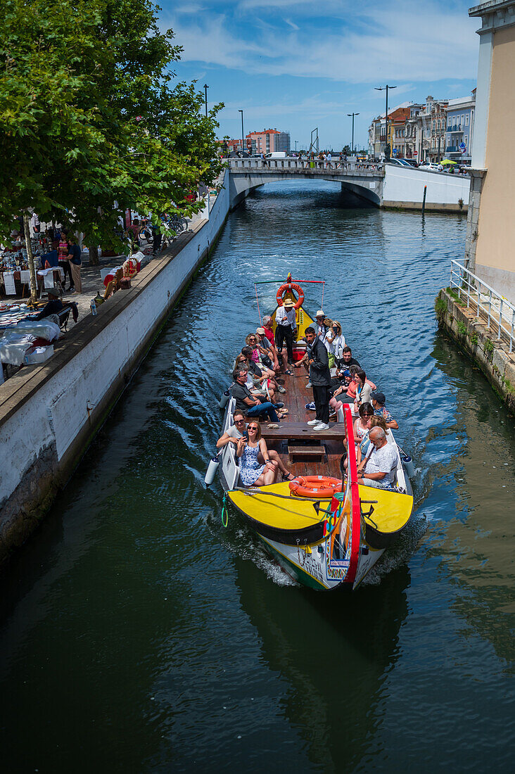 Boat ride through canals in a colorful and traditional Moliceiro boat, Aveiro, Portugal