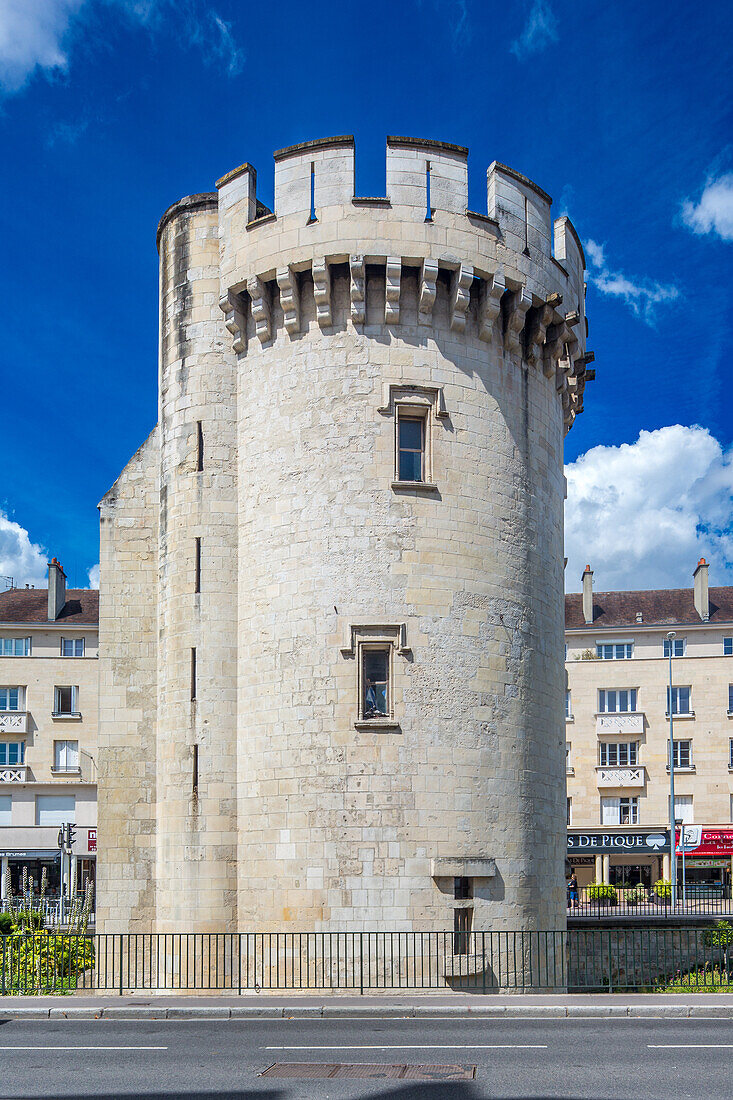 Ancient stone King William Tower located in Caen, Normandy, France. Clear blue sky and urban background with surrounding buildings.