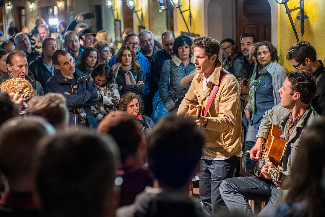 American duo The Cactus Blossom performing at Plaza Mayor in Riaza, Segovia, Spain during Huercasa Country Festival 2017. Enthusiastic crowd gathered around.