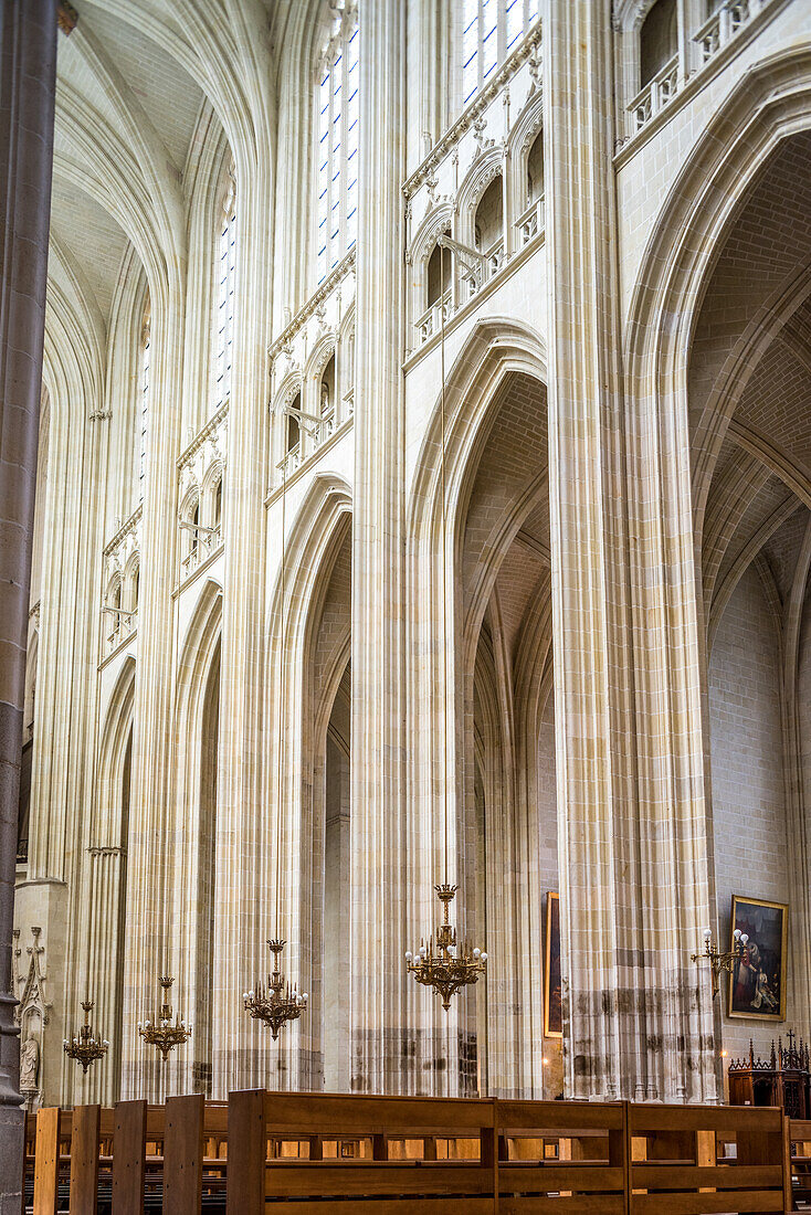 Gothic architecture and ornate chandeliers inside Saint Pierre et Saint Paul Cathedral in Nantes, France. Stunning architectural details and historical significance.