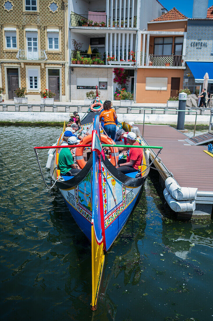 Boat ride through canals in a colorful and traditional Moliceiro boat, Aveiro, Portugal