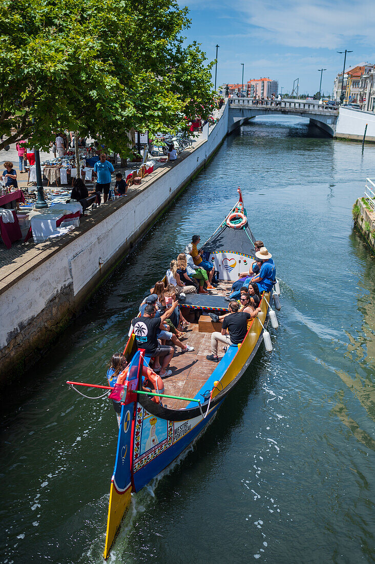 Boat ride through canals in a colorful and traditional Moliceiro boat, Aveiro, Portugal