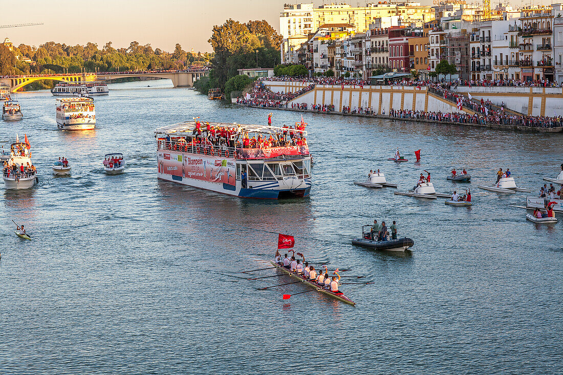 Sevilla FC players celebrate their 2007 UEFA Cup win on a boat ride along the scenic Guadalquivir River in Sevilla, Andalusia, Spain.