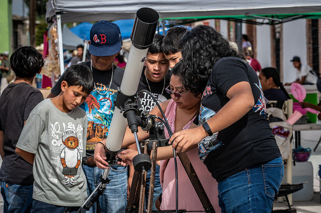 Community looking at telescope for the eclipse in Mapimi, Mexico.