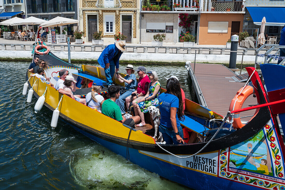 Boat ride through canals in a colorful and traditional Moliceiro boat, Aveiro, Portugal