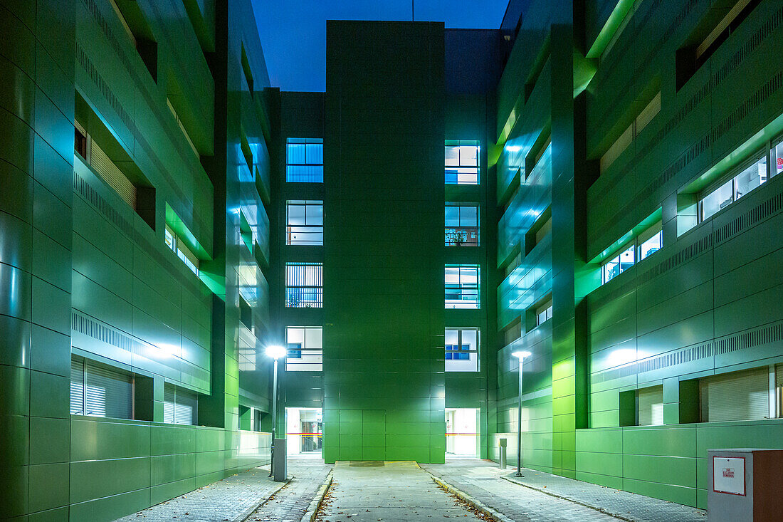 Night view of the Facultad de Biología at the Campus de Reina Mercedes, Universidad de Sevilla, showcasing modern architecture.