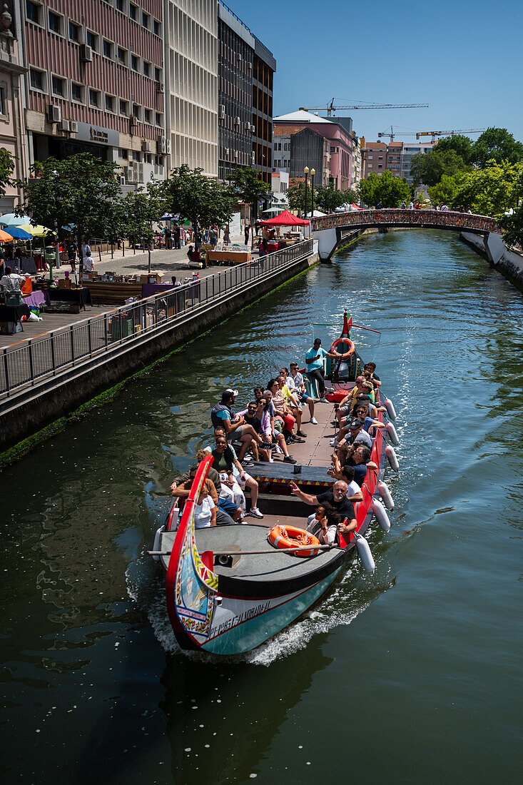 Boat ride through canals in a colorful and traditional Moliceiro boat, Aveiro, Portugal