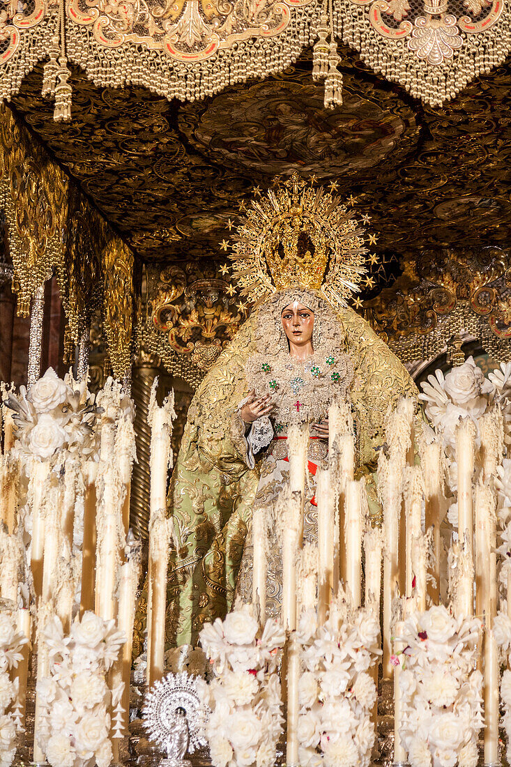 The Virgin of Hope Macarena adorned with candles after the Good Friday procession during the Semana Santa celebration in Seville, Spain.