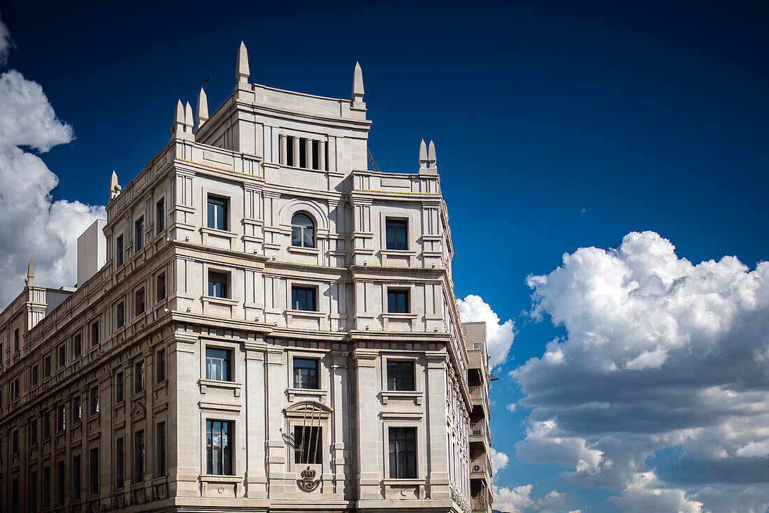 Beautiful view of the historic Edificio de Correos in Granada, Andalusia, Spain with blue sky and clouds.