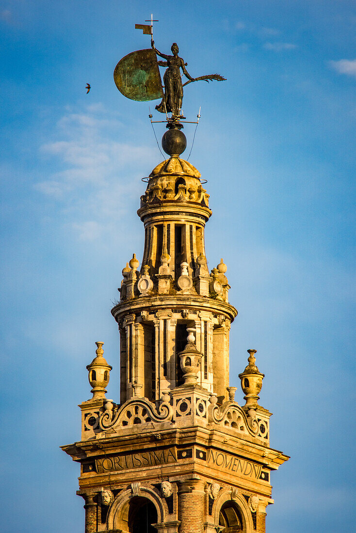 Close-up of the statue of Faith at the top of La Giralda, the iconic bell tower in Seville, Spain.