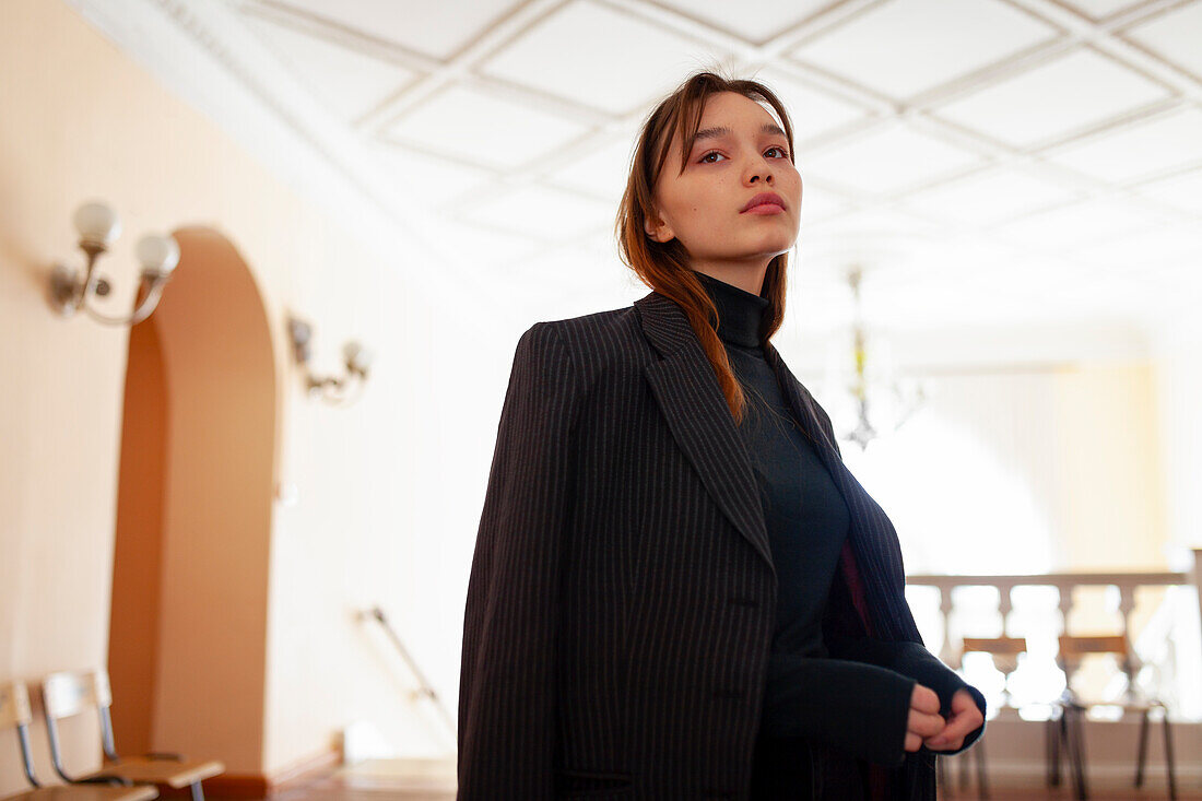 Portrait of woman standing in hallway