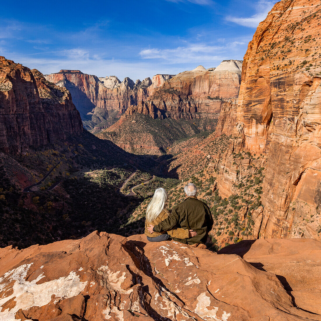 Rear view of senior couple looking at Zion Canyon from Zion Overlook