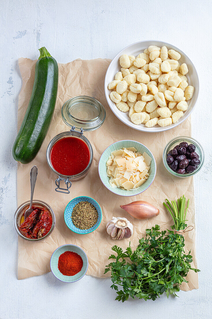 Ingredients for gnocchi with tomato sauce, zucchinis and olives