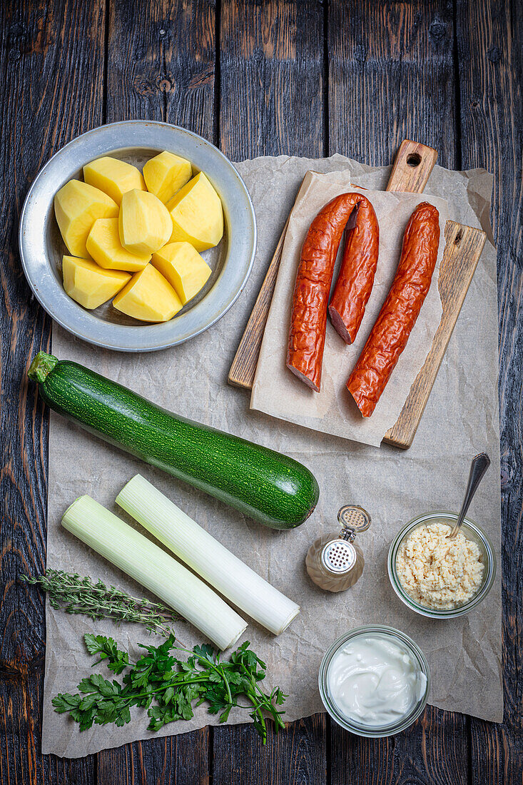 Ingredients for potato casserole with sausage and vegetables