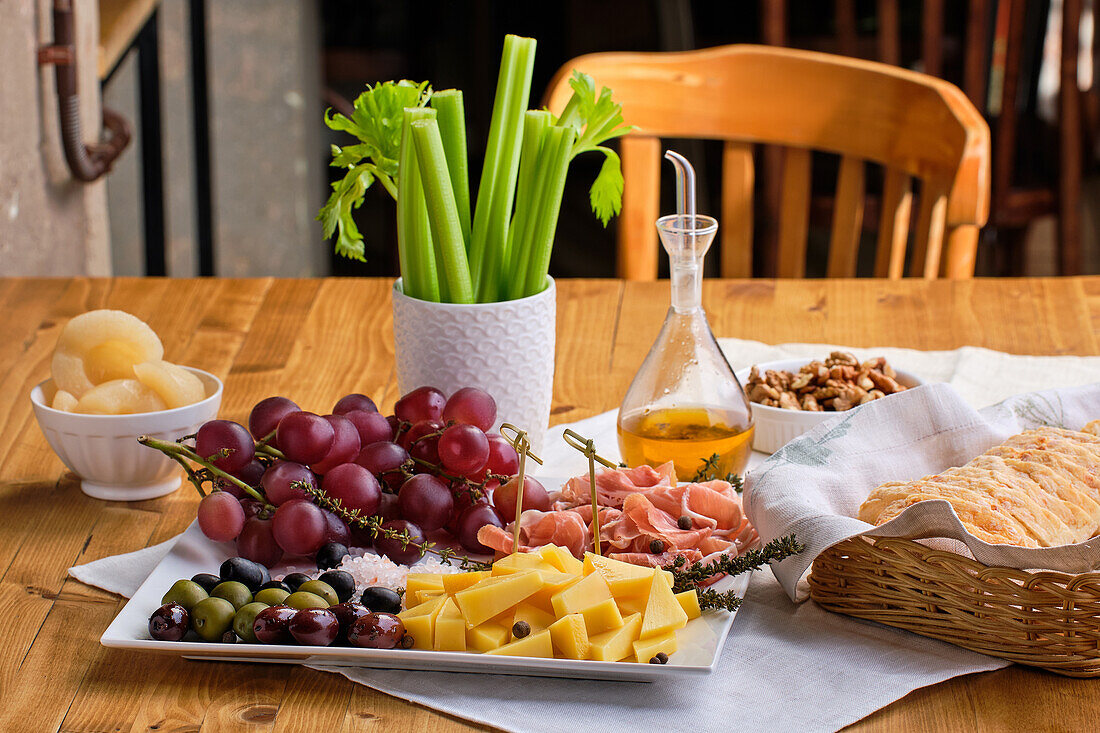 Antipasti platter with cheese, ham, grapes and olives