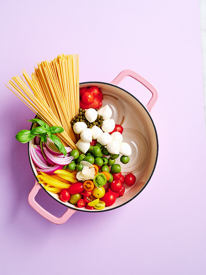 Ingredients for spaghetti in mozzarella tomato sauce with olives