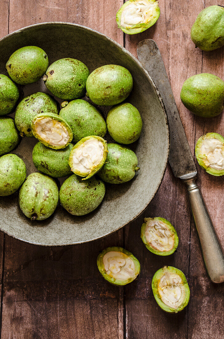 Green walnuts, partly halved, for walnut liqueur