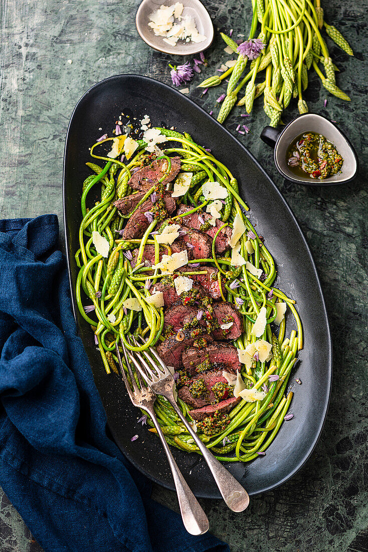 Wild asparagus salad with fried steak strips and chimichurri