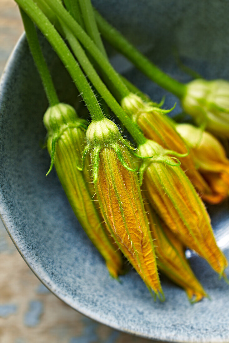 Courgette flowers in a ceramic bowl