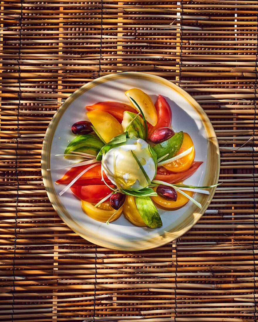 Colourful caprese salad with mozzarella and olives