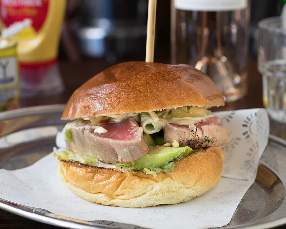 Tuna burger with avocado and salad