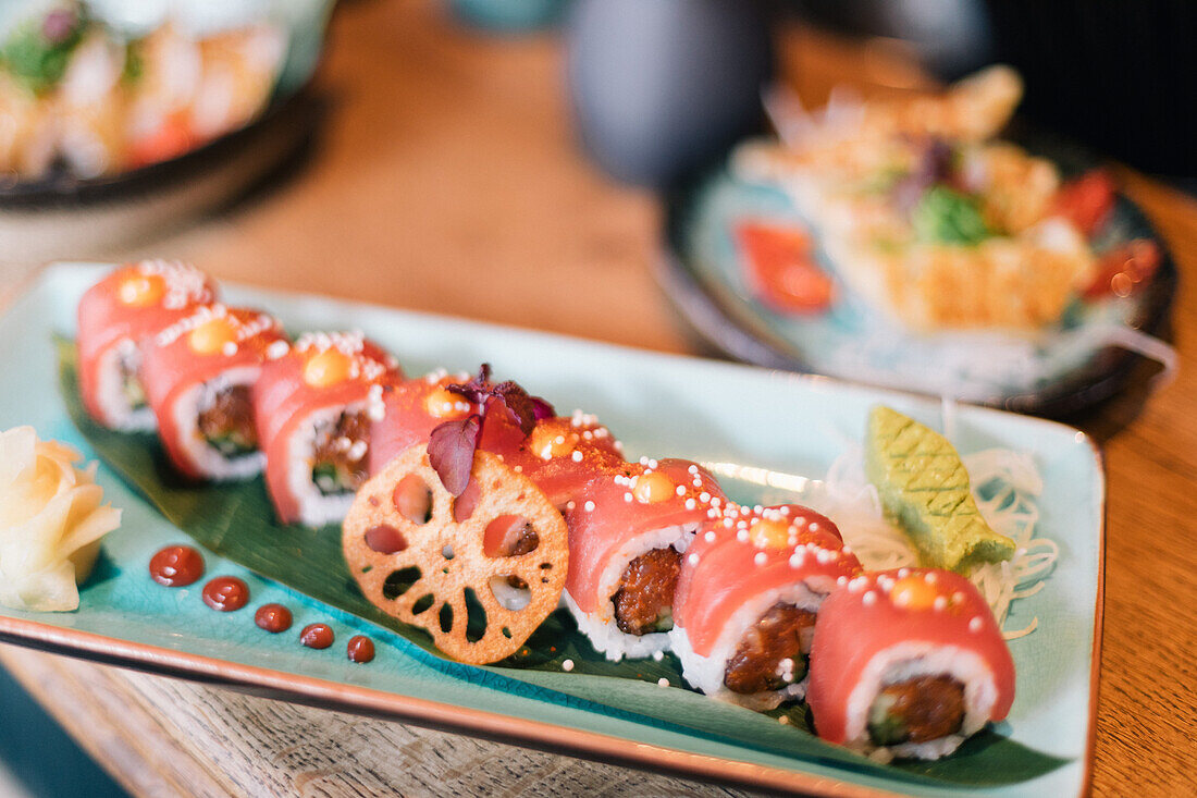 Spicy tuna sushi roll with wasabi and ginger