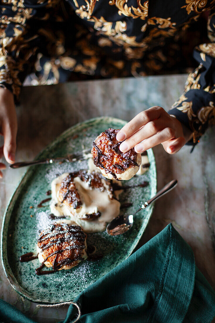 Profiteroles mit Schokoladensauce und Puderzucker