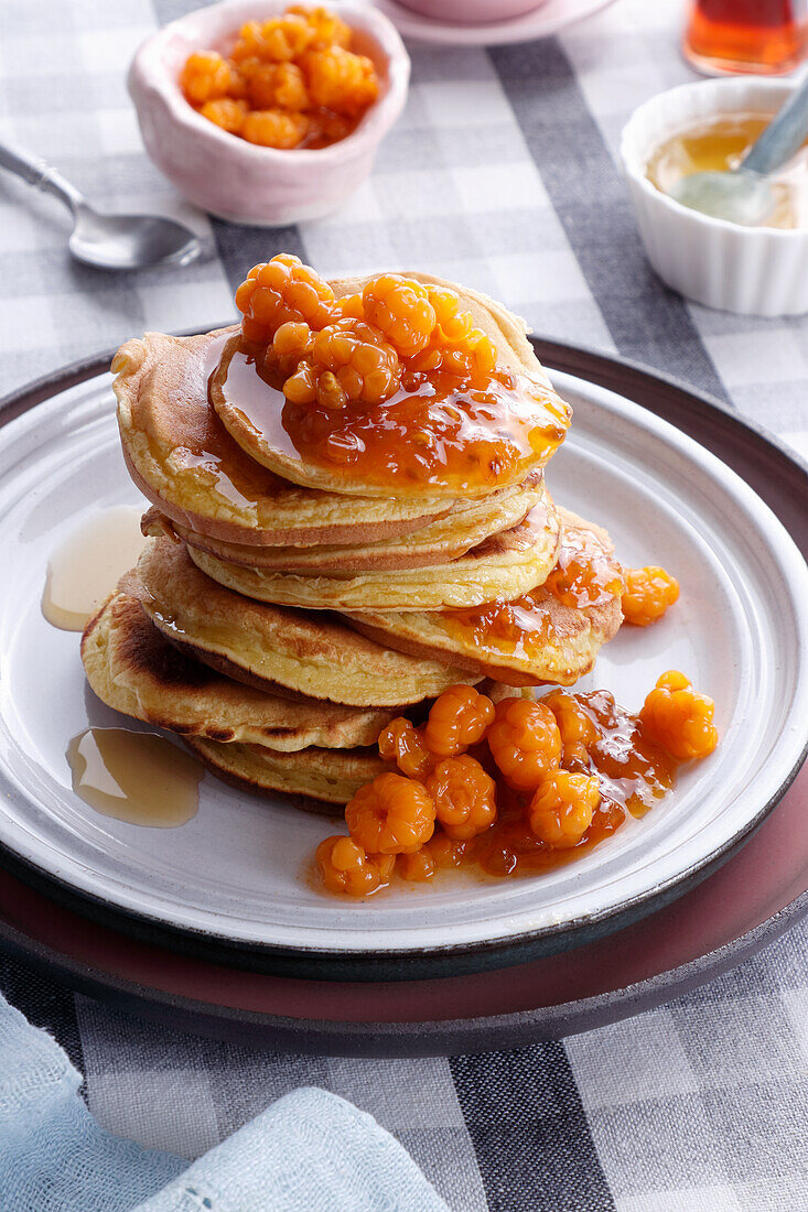 Pancakes with cloudberries and maple syrup