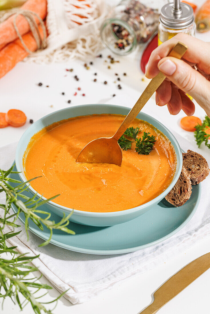 Creamy vegan carrot soup with fresh parsley