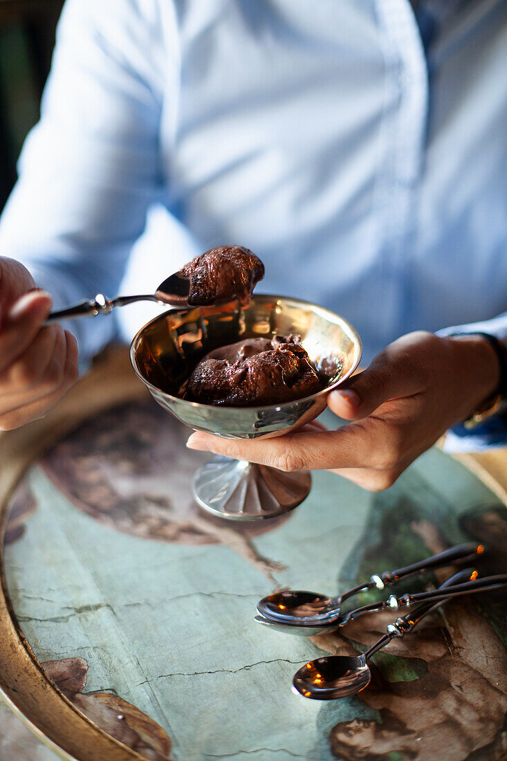 Chocolate ice cream in a silver bowl