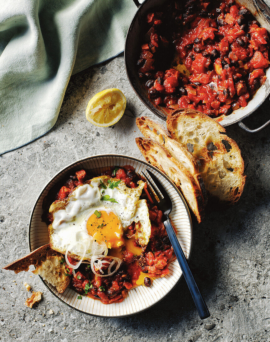 Shakshuka with fried egg and toasted bread