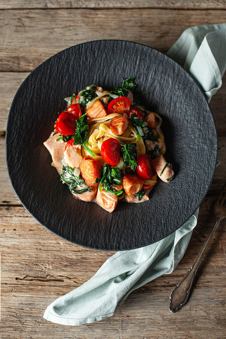 Linguine with salmon, cherry tomatoes and baby spinach