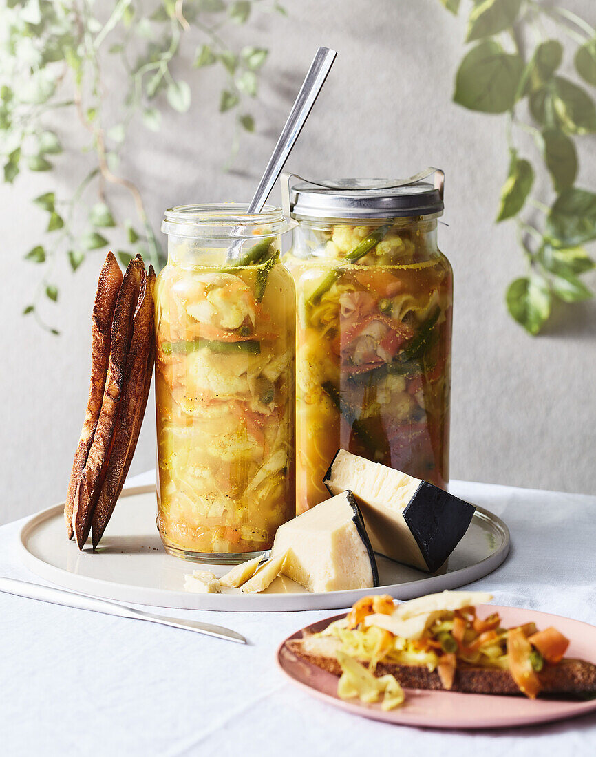 Homemade piccalilli - pickled vegetables with cheese and bread