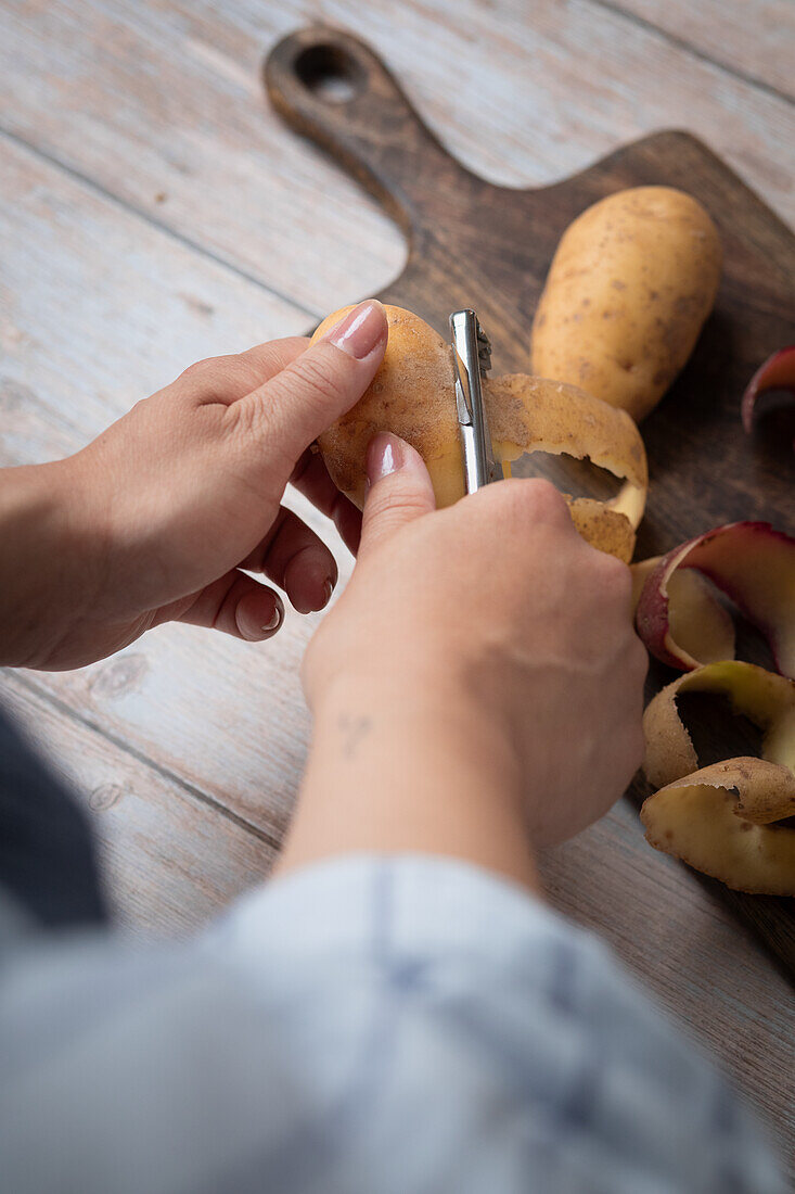 Peeling potatoes with a peeler