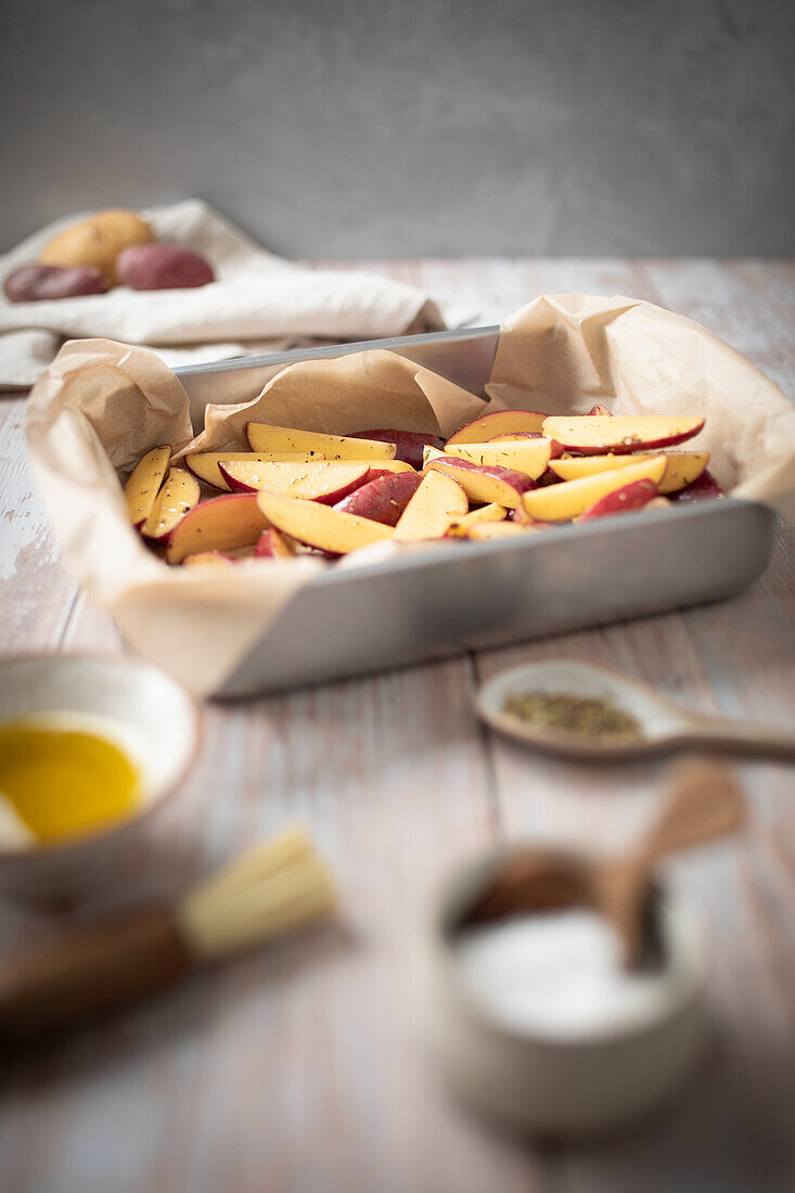 Preparing jacket potatoes with spices and olive oil