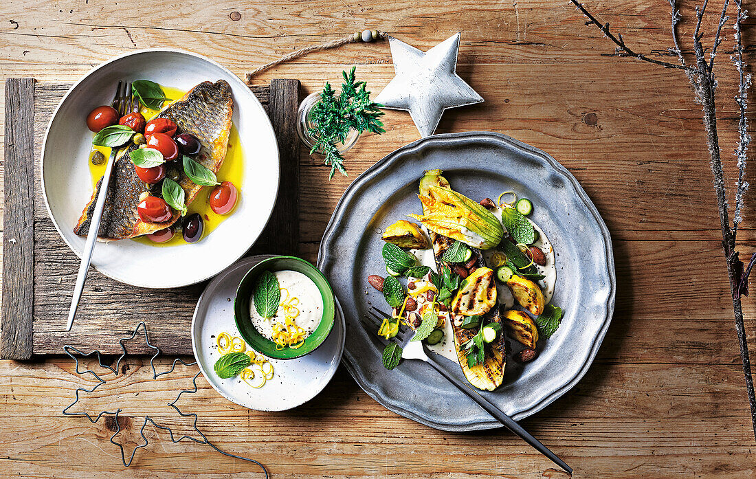 Grilled fish fillet with olives and tomatoes and courgette squash salad