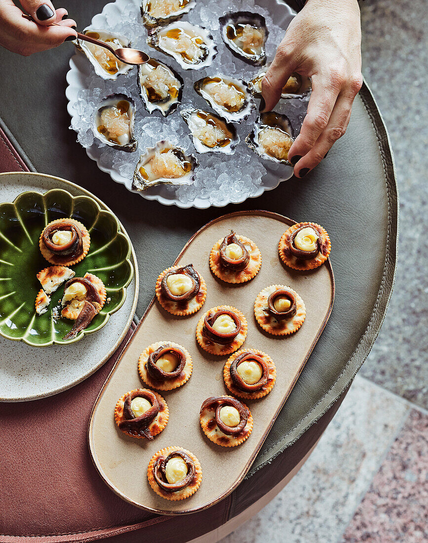 Oysters with pomelo and kombu oil, crackers with smoked butter and anchovies