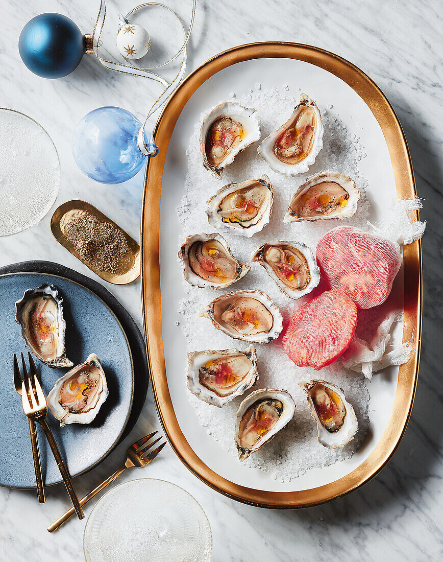 Rock oysters with ox heart tomato on a coarse salt carpet