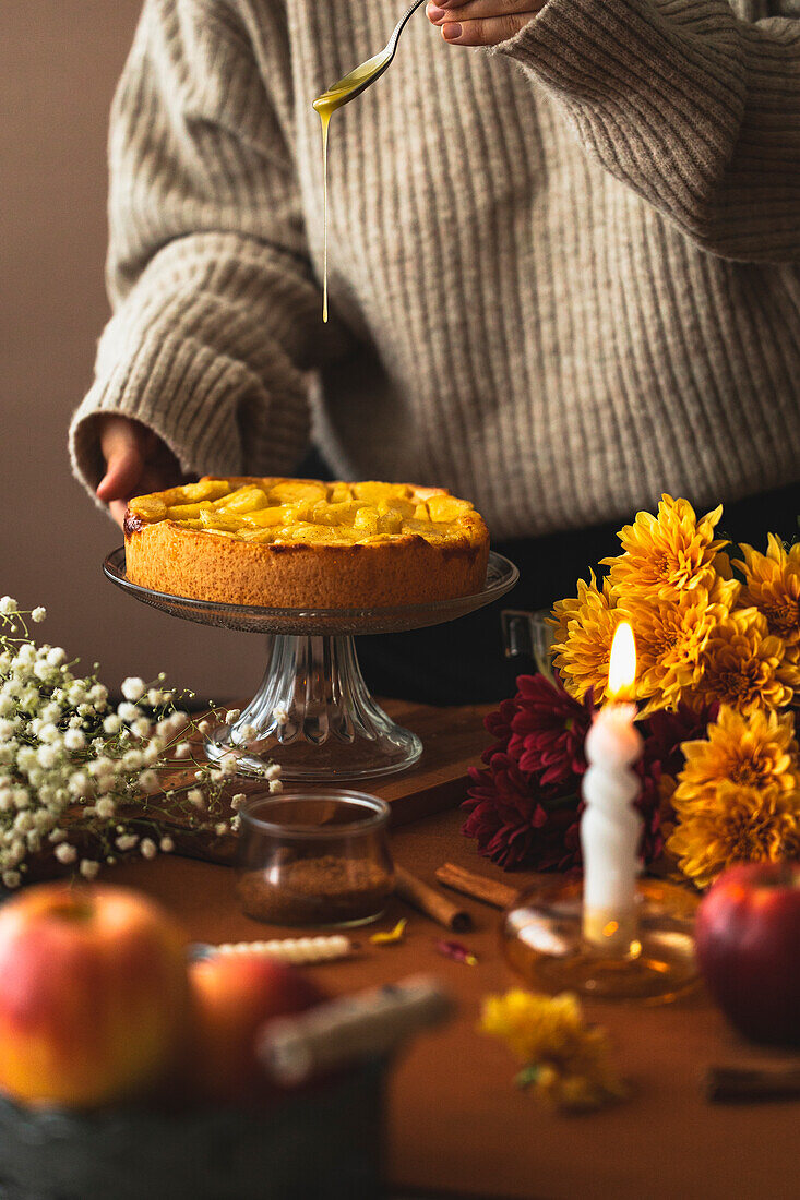 Apple cake with icing and autumnal decoration