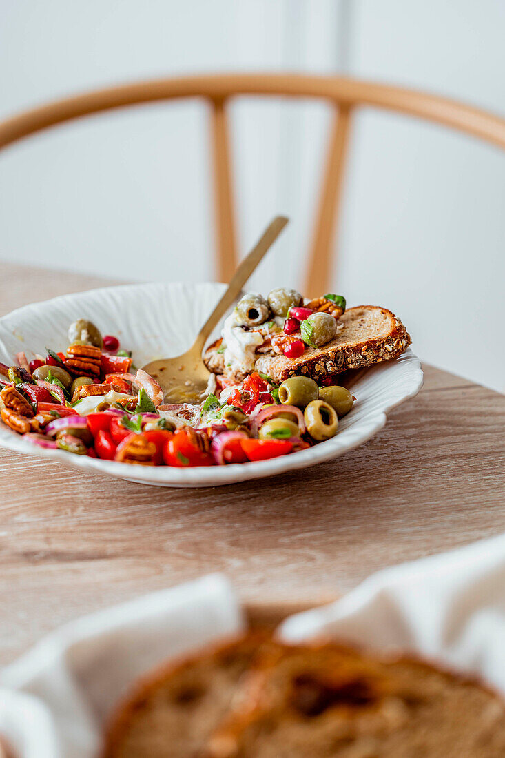 Summer salad with tomatoes, olives and pecans